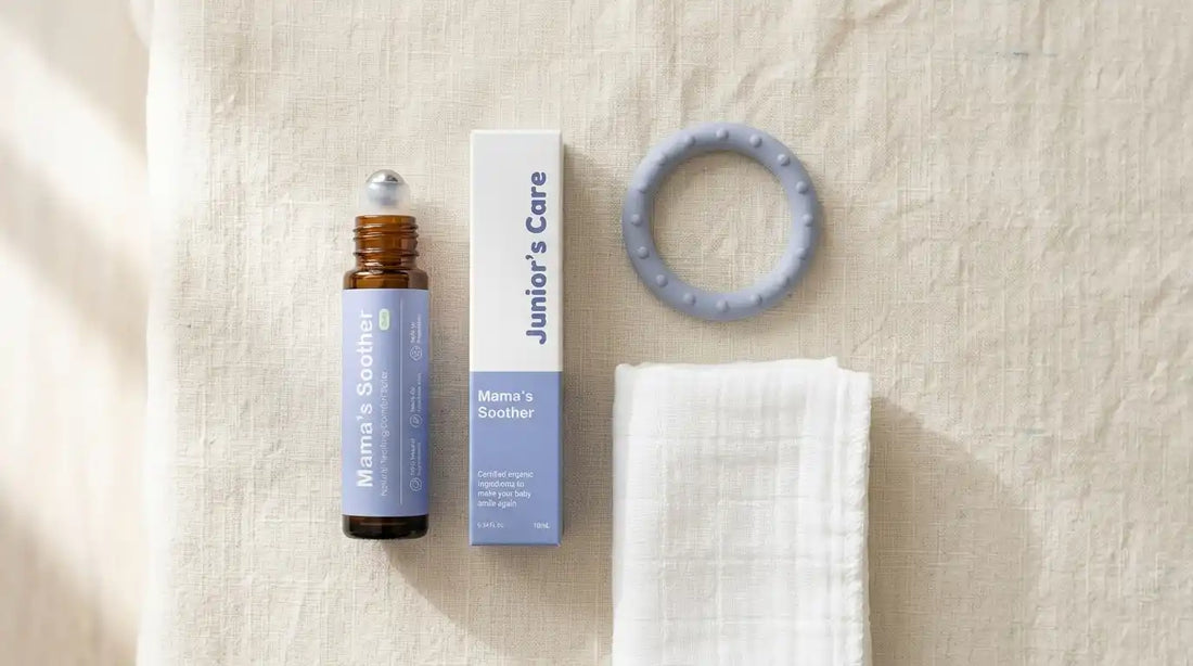 Silicone teething ring, roll-on bottle and washcloth on linen.